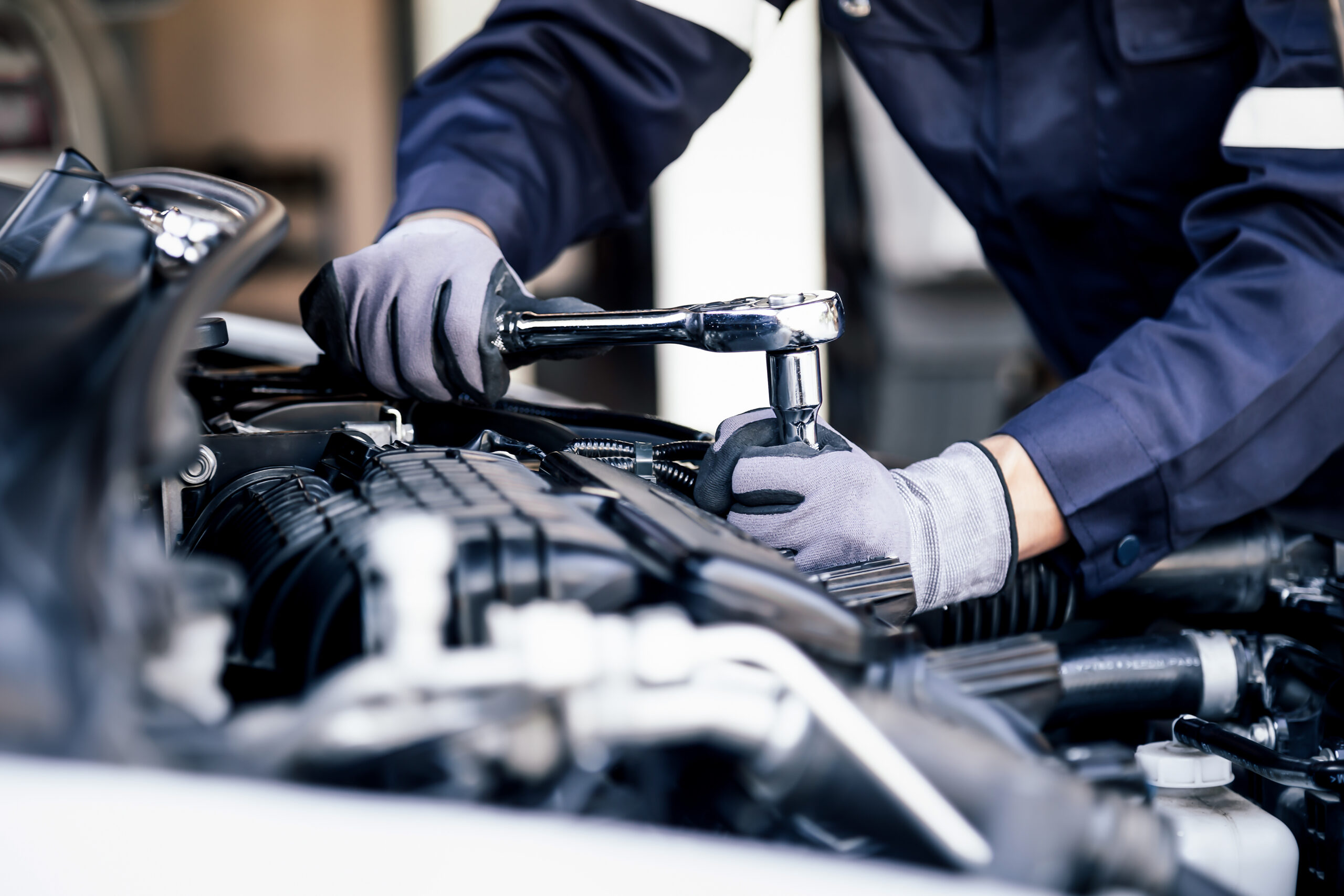 Professional mechanic working on the engine of the car in the ga Avada Car Dealer News